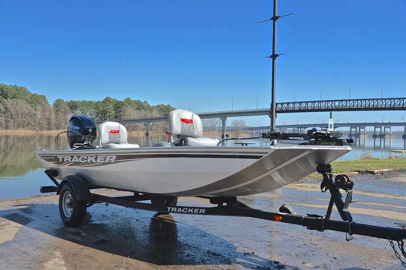Slide: The Image of 2017 Bass Tracker Pro 16 boat on trailer by a scenic river and bridge. - 16