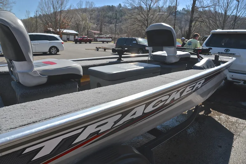 Slide: The Image of 2017 Bass Tracker Pro 16 boat in parking lot, featuring comfortable seating and sleek design. - 19