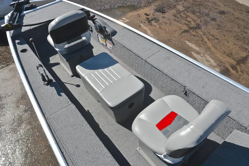 Slide: The Image of 2017 Bass Tracker Pro 16 boat interior with gray seating and carpeted flooring. - 22