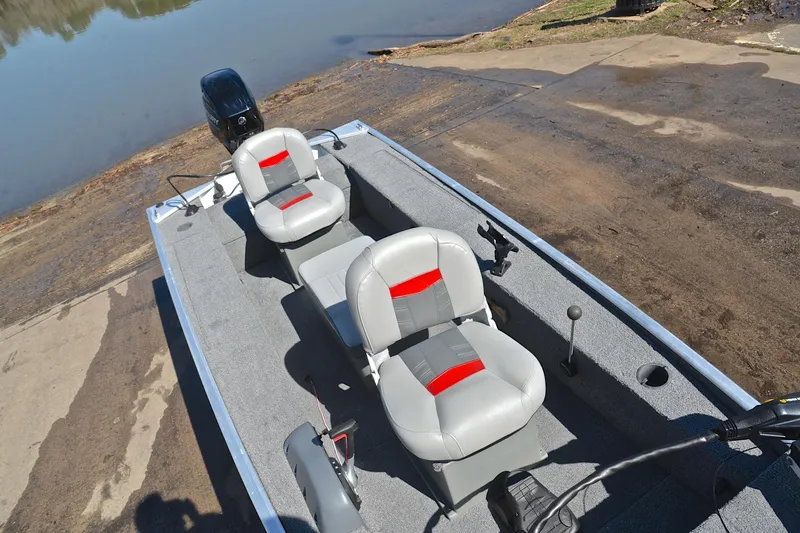 Slide: The Image of 2017 Bass Tracker Pro 16 boat with dual seats near a lake. - 23