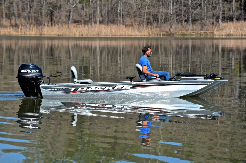 Slide: The Image of 2017 Bass Tracker Pro 16 boat on calm lake with Mercury engine. - 7