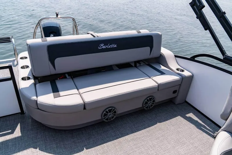 Slide: The Image of Manufacturer Provided Image: 2026 Barletta ARIA 22UC pontoon boat with luxurious seating and cup holders on a calm lake. - 2