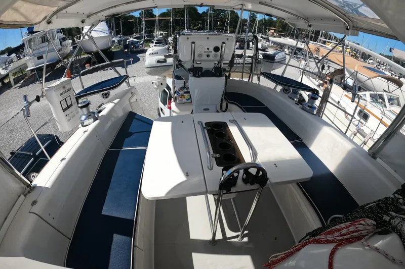 Slide: The Image of 2005 Catalina Morgan 440 yacht interior with seating and navigation equipment in a marina. - 10