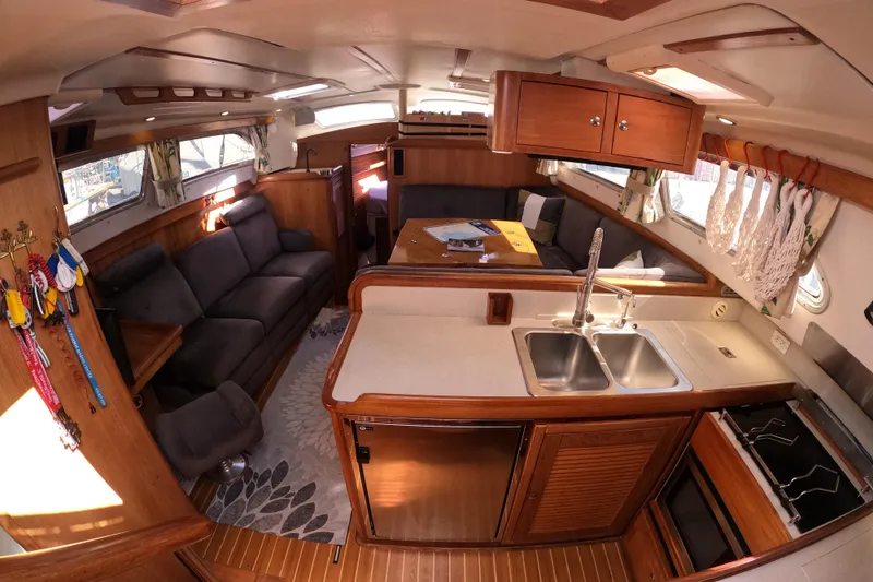 Slide: The Image of Luxurious 2005 Catalina Morgan 440 yacht interior with cozy seating and modern kitchen amenities. - 20