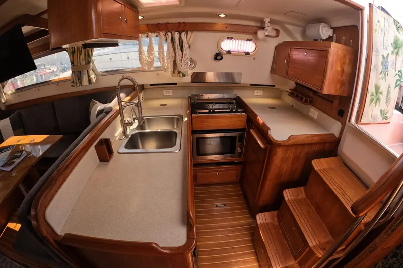 Slide: The Image of Luxurious 2005 Catalina Morgan 440 yacht interior with modern kitchen and cozy seating area. - 22