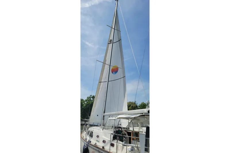 Slide: The Image of Sailboat Catalina Morgan 440, 2005 model, with sails raised against a clear sky. - 3