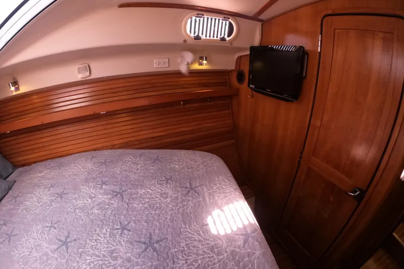 Slide: The Image of Cozy cabin interior of 2005 Catalina Morgan 440 yacht with wood paneling and TV. - 30