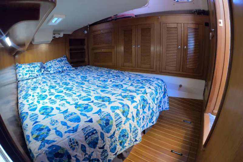 Slide: The Image of Cozy cabin interior of 2005 Catalina Morgan 440 with blue patterned bedding. - 34