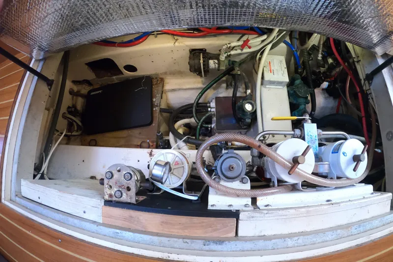 Slide: The Image of Engine compartment of a 2005 Catalina Morgan 440 sailboat, showcasing mechanical components and wiring. - 38
