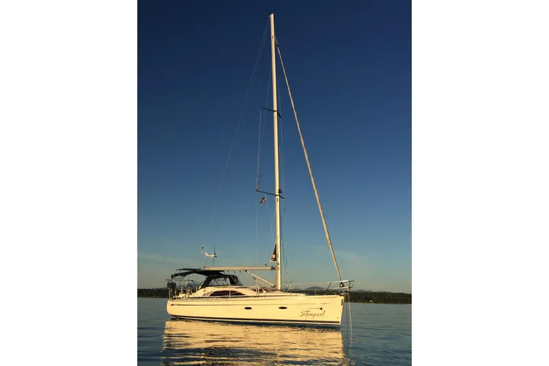 The Image of 2008 Bavaria 40 Vision sailboat on calm water under clear blue sky. - 0