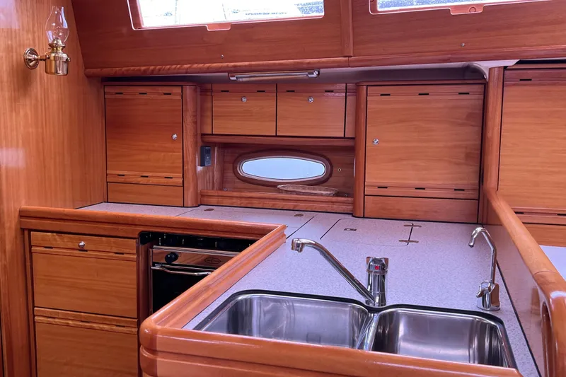 Slide: The Image of Interior of 2008 Bavaria 40 Vision yacht kitchen with wooden cabinets and stainless steel sink. - 19
