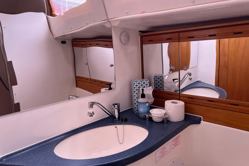 Slide: The Image of Bathroom interior of 2008 Bavaria 40 Vision yacht with sink, mirror, and toiletries. - 26