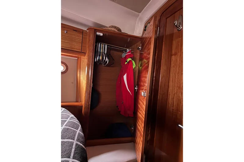 Slide: The Image of Wooden closet interior on 2008 Bavaria 40 Vision yacht with hanging clothes. - 32