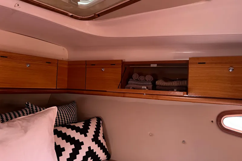 Slide: The Image of Interior of 2008 Bavaria 40 Vision yacht with wooden cabinets and patterned cushions. - 33