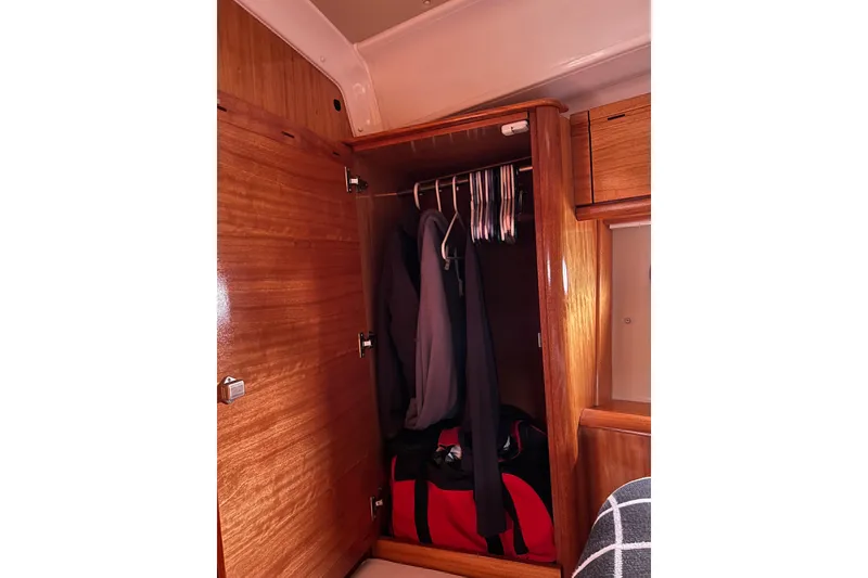 Slide: The Image of Wooden closet interior on 2008 Bavaria 40 Vision yacht with hanging clothes and bag. - 35