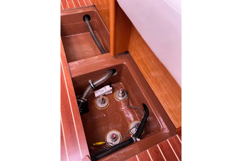 Slide: The Image of Bilge compartment of a 2008 Bavaria 40 Vision sailboat, showing hoses and wiring. - 36
