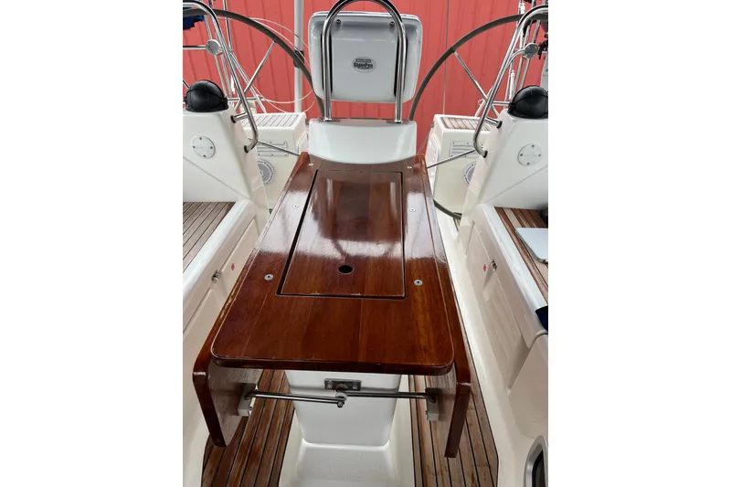 Slide: The Image of Cockpit of 2008 Bavaria 40 Vision yacht with polished wooden table and dual steering wheels. - 6
