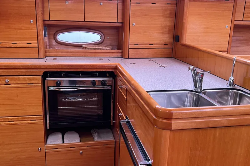 Slide: The Image of Luxurious wooden kitchen interior of 2008 Bavaria 40 Vision yacht with oven and double sink. - 17