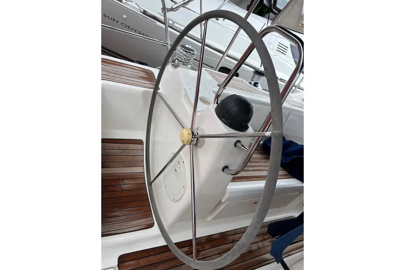 Slide: The Image of Steering wheel of a 2008 Bavaria 40 Vision yacht with wooden deck details. - 2