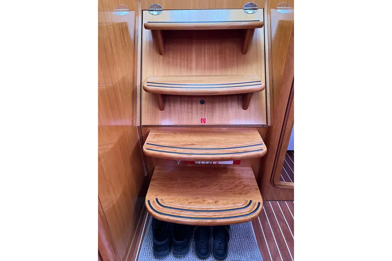 Slide: The Image of Wooden interior steps of a 2008 Bavaria 40 Vision yacht with shoes underneath. - 39