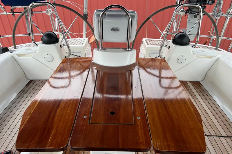 Slide: The Image of Cockpit of 2008 Bavaria 40 Vision yacht with polished wooden table and dual steering wheels. - 7