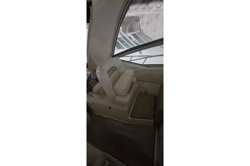 Slide: The Image of 2009 Sea Ray Sundancer 350 interior with white seating and window view. - 12