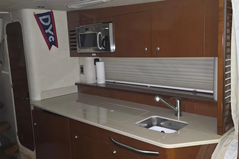 Slide: The Image of Interior of 2009 Sea Ray Sundancer 350 yacht kitchen with microwave and sink. - 15