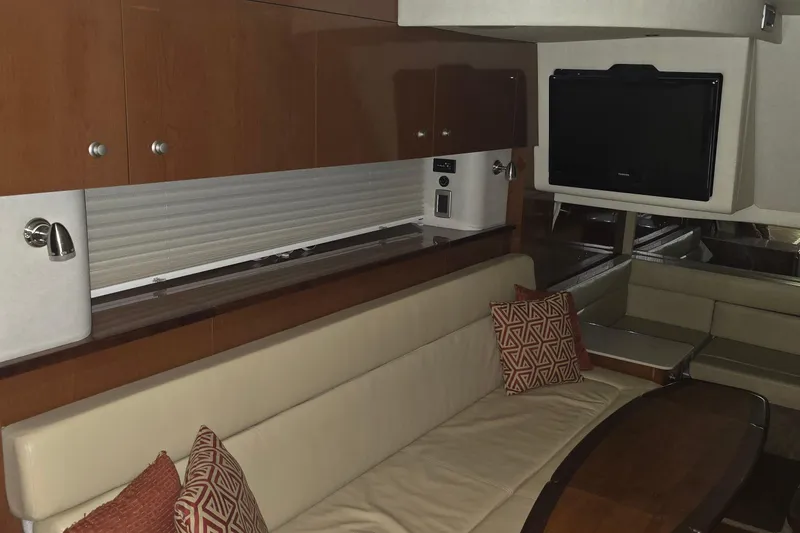 Slide: The Image of Interior of 2009 Sea Ray Sundancer 350 yacht with seating, TV, and wooden cabinetry. - 18