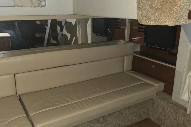 Slide: The Image of Interior of 2009 Sea Ray Sundancer 350 with beige seating and TV. - 21