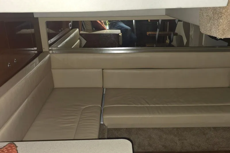 Slide: The Image of Interior of 2009 Sea Ray Sundancer 350 with beige leather seating and mirrored wall. - 22