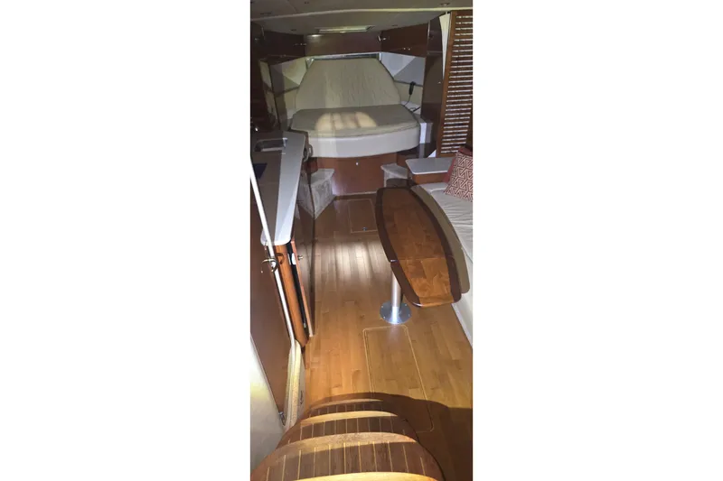 Slide: The Image of Interior of 2009 Sea Ray Sundancer 350 yacht with wooden flooring and cozy seating area. - 24