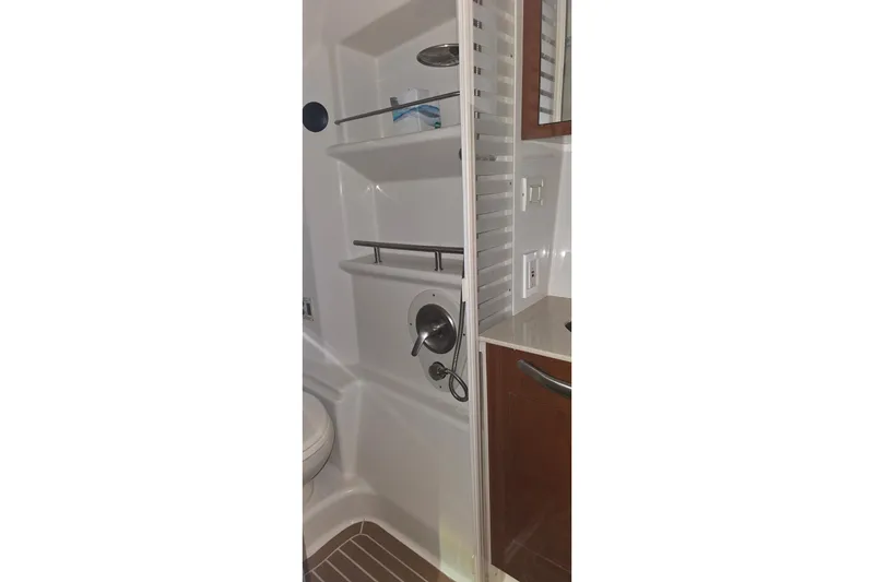 Slide: The Image of 2009 Sea Ray Sundancer 350 bathroom with shower and wooden cabinetry. - 29