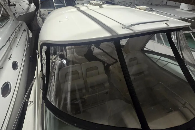 Slide: The Image of 2009 Sea Ray Sundancer 350 yacht in storage, featuring a sleek white exterior and spacious interior. - 5