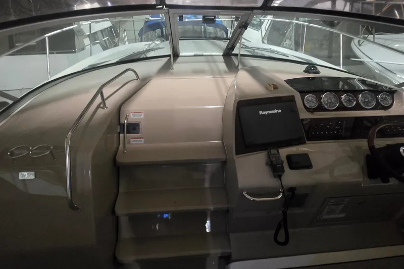 Slide: The Image of 2009 Sea Ray Sundancer 350 helm with Raymarine navigation system and gauges. - 9