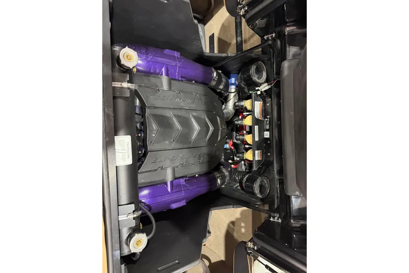 Slide: The Image of 2023 MasterCraft X24 engine compartment with visible components and wiring. - 14