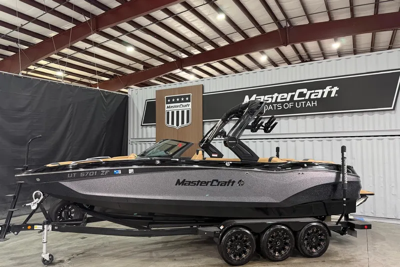 Slide: The Image of 2023 MasterCraft X24 boat displayed indoors at MasterCraft Boats of Utah. - 2