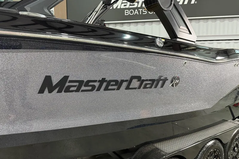 Slide: The Image of 2023 MasterCraft X24 boat with sleek metallic finish and logo. - 3