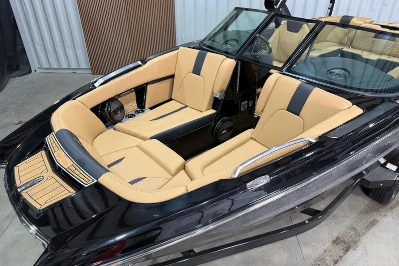 Slide: The Image of 2023 MasterCraft X24 boat interior with luxurious tan and black seating. - 4
