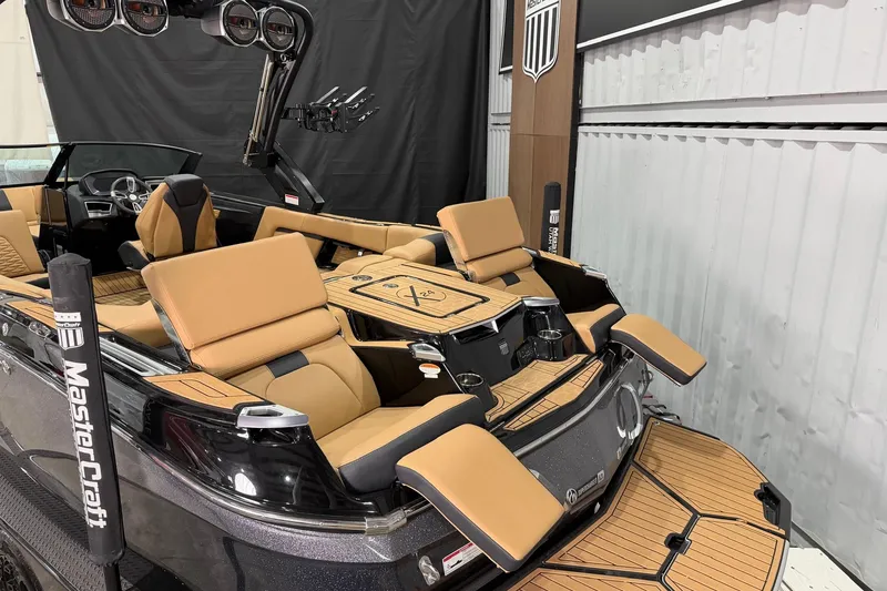 Slide: The Image of 2023 MasterCraft X24 boat with luxurious tan seating and sleek design. - 6