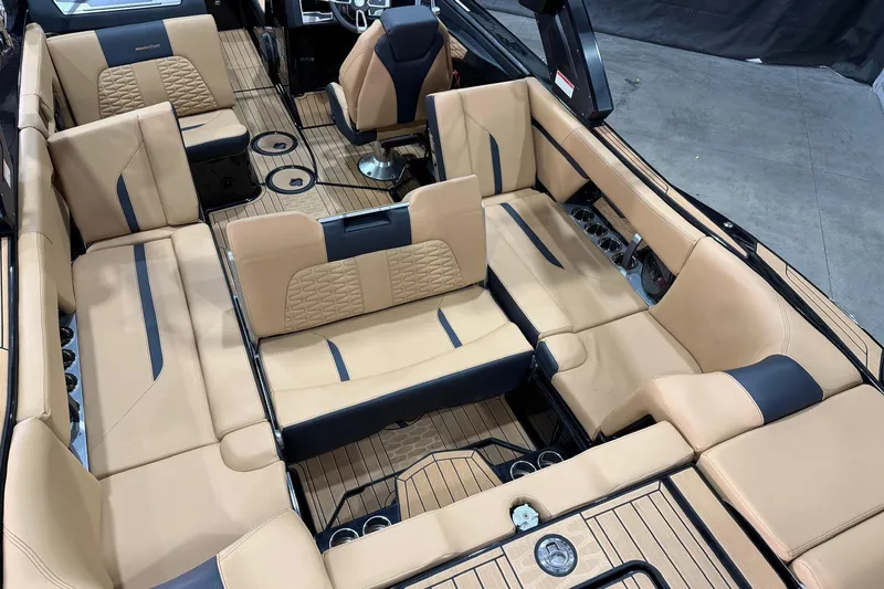 Slide: The Image of 2023 MasterCraft X24 boat interior with luxurious tan seating and sleek design. - 7