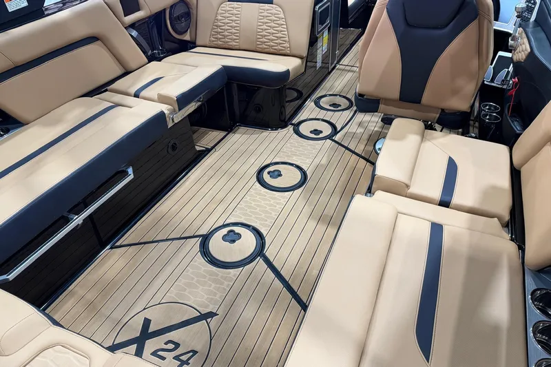 Slide: The Image of 2023 MasterCraft X24 boat interior with luxurious tan and black seating. - 8