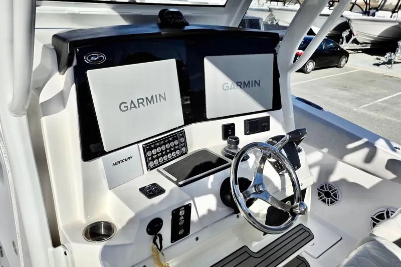 Slide: The Image of 2023 Sea Fox 328 Commander helm with dual Garmin displays and Mercury controls. - 11