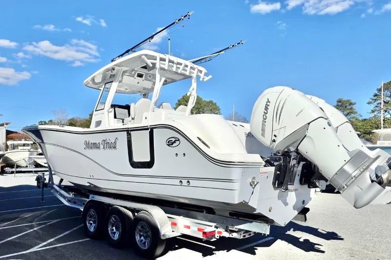 Slide: The Image of 2023 Sea Fox 328 Commander boat on trailer with dual Mercury engines, under clear blue sky. - 20
