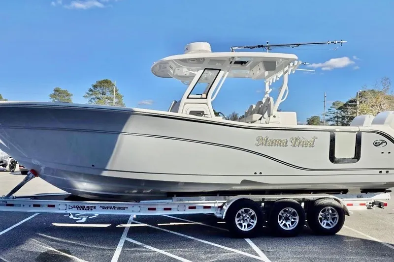 Slide: The Image of 2023 Sea Fox 328 Commander boat on trailer under clear blue sky. - 21