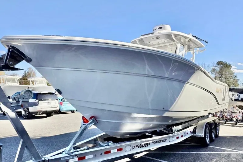 Slide: The Image of 2023 Sea Fox 328 Commander boat on trailer under clear blue sky. - 22