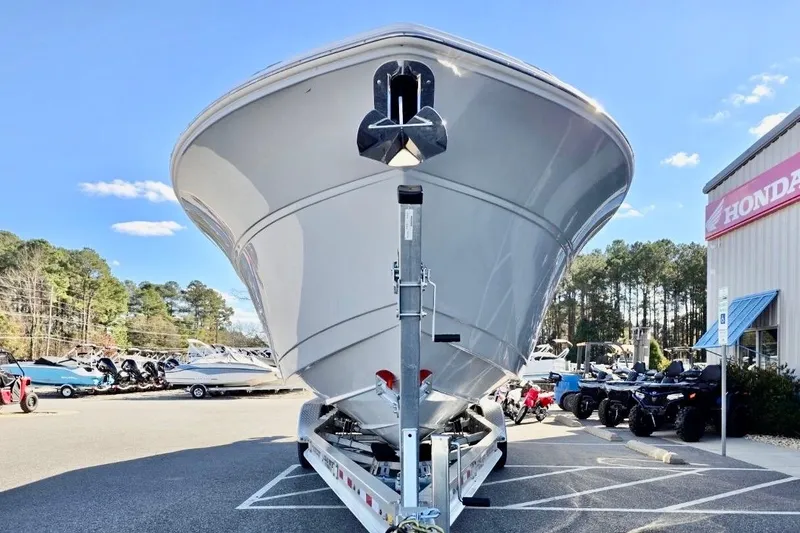 Slide: The Image of 2023 Sea Fox 328 Commander boat on trailer at dealership, clear sky background. - 23
