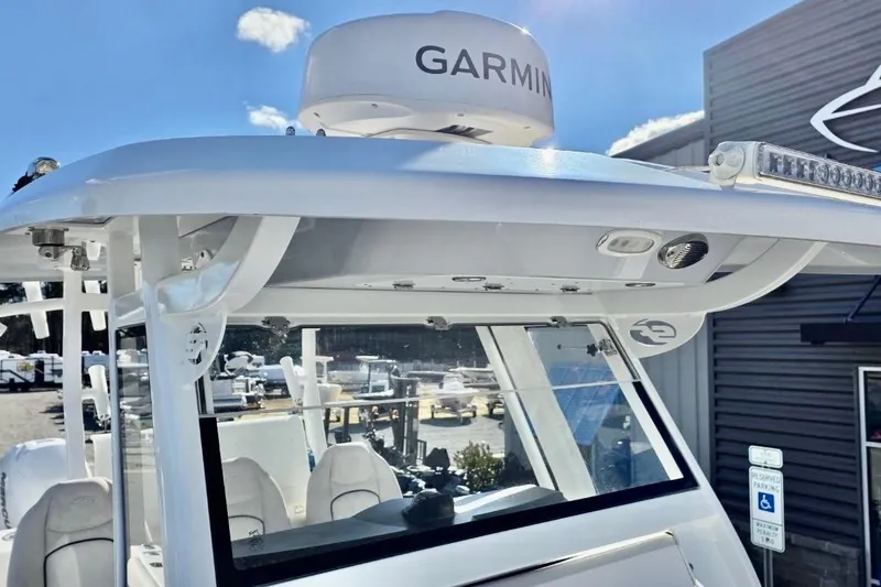 Slide: The Image of 2023 Sea Fox 328 Commander boat with Garmin radar, docked under clear blue sky. - 3