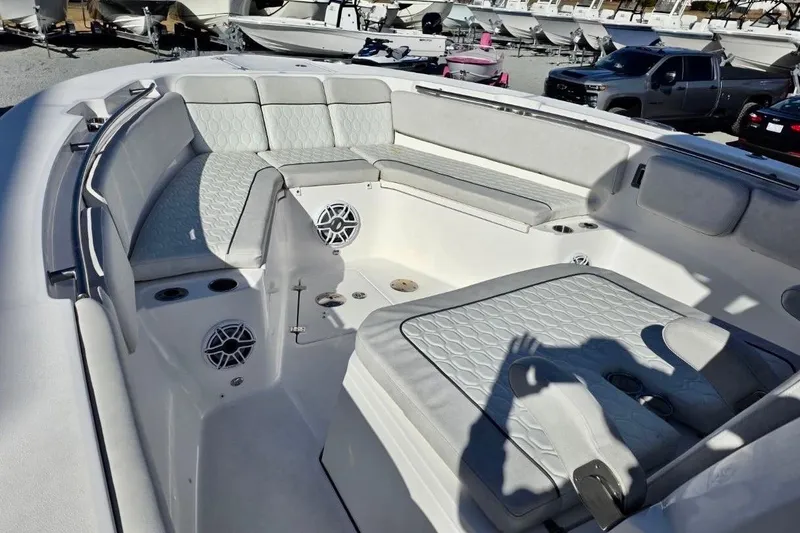 Slide: The Image of 2023 Sea Fox 328 Commander boat interior with cushioned seating and cup holders. - 5