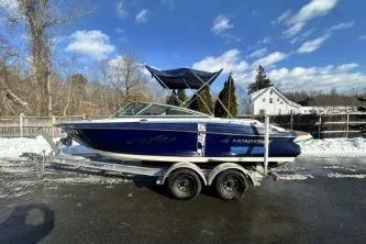 The Image of 2014 Monterey 204FS boat on trailer, parked outdoors on a sunny day. - 1