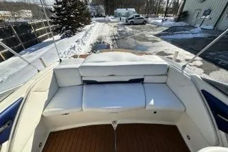 Slide: The Image of 2014 Monterey 204FS boat interior with white seating and wooden flooring. - 11